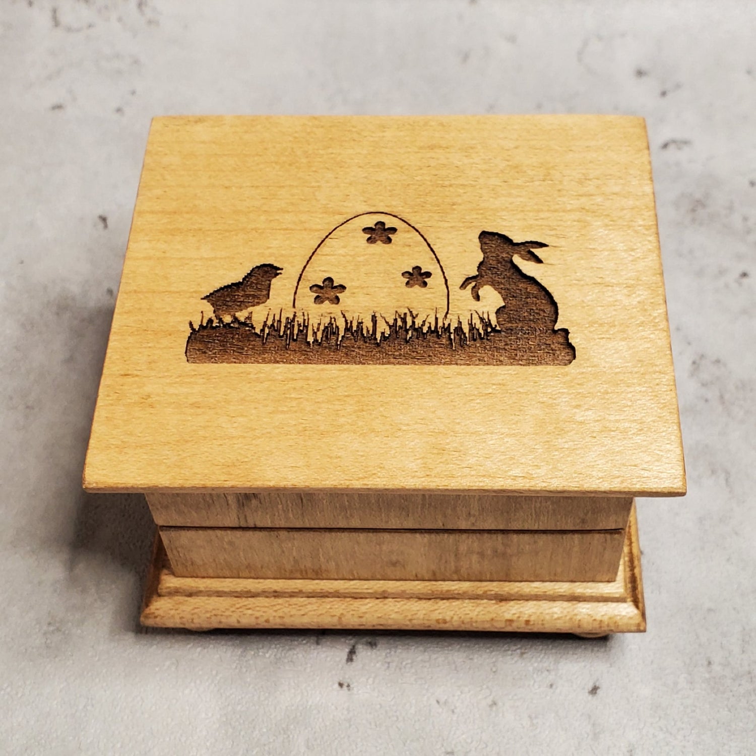 Easter music box with Easter egg, Easter bunny and baby chick engraved on top of the music box with a name under the image, choose color and song