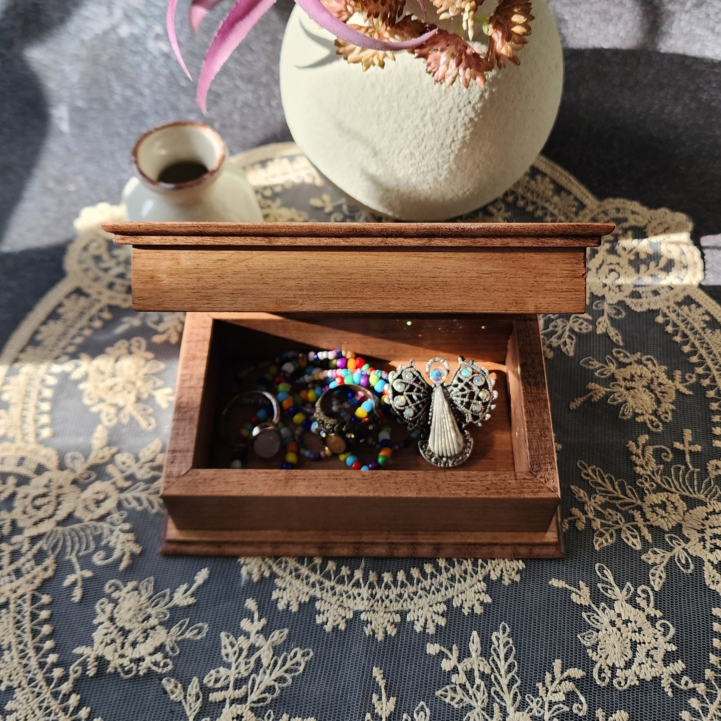 Decorative box with jewelry on a textured surface