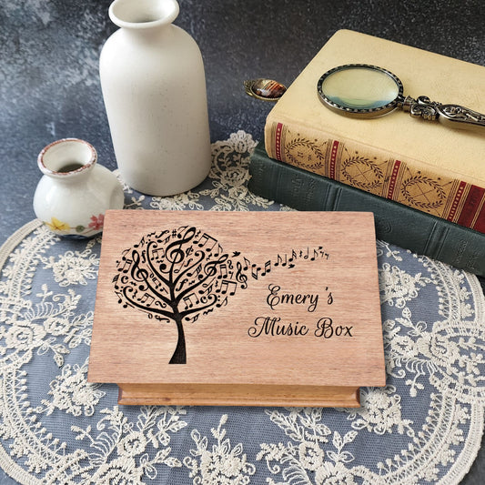 Personalized wooden jewelry box with engraved music tree design and name ‘Emery’s Music Box,’ handcrafted custom song box in natural wood color