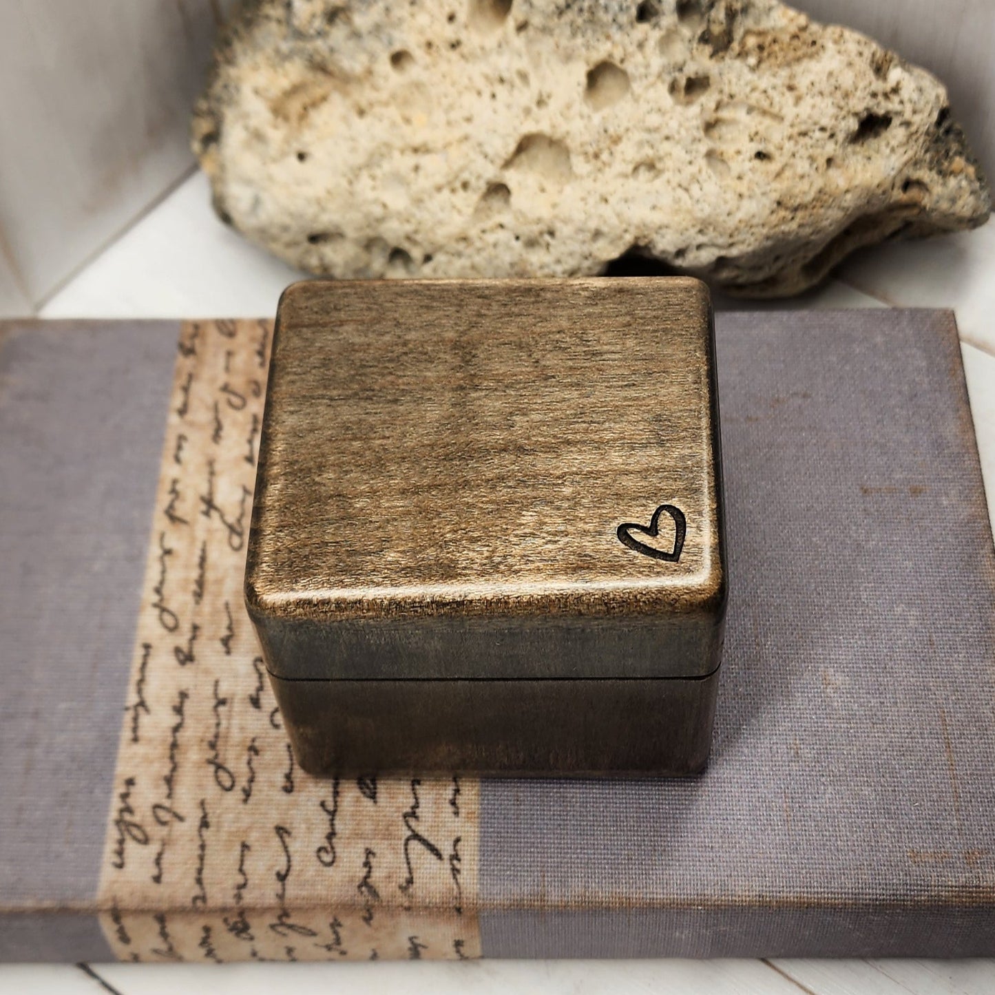 wooden ring box with a tiny heart engraved in the corner, plays your song