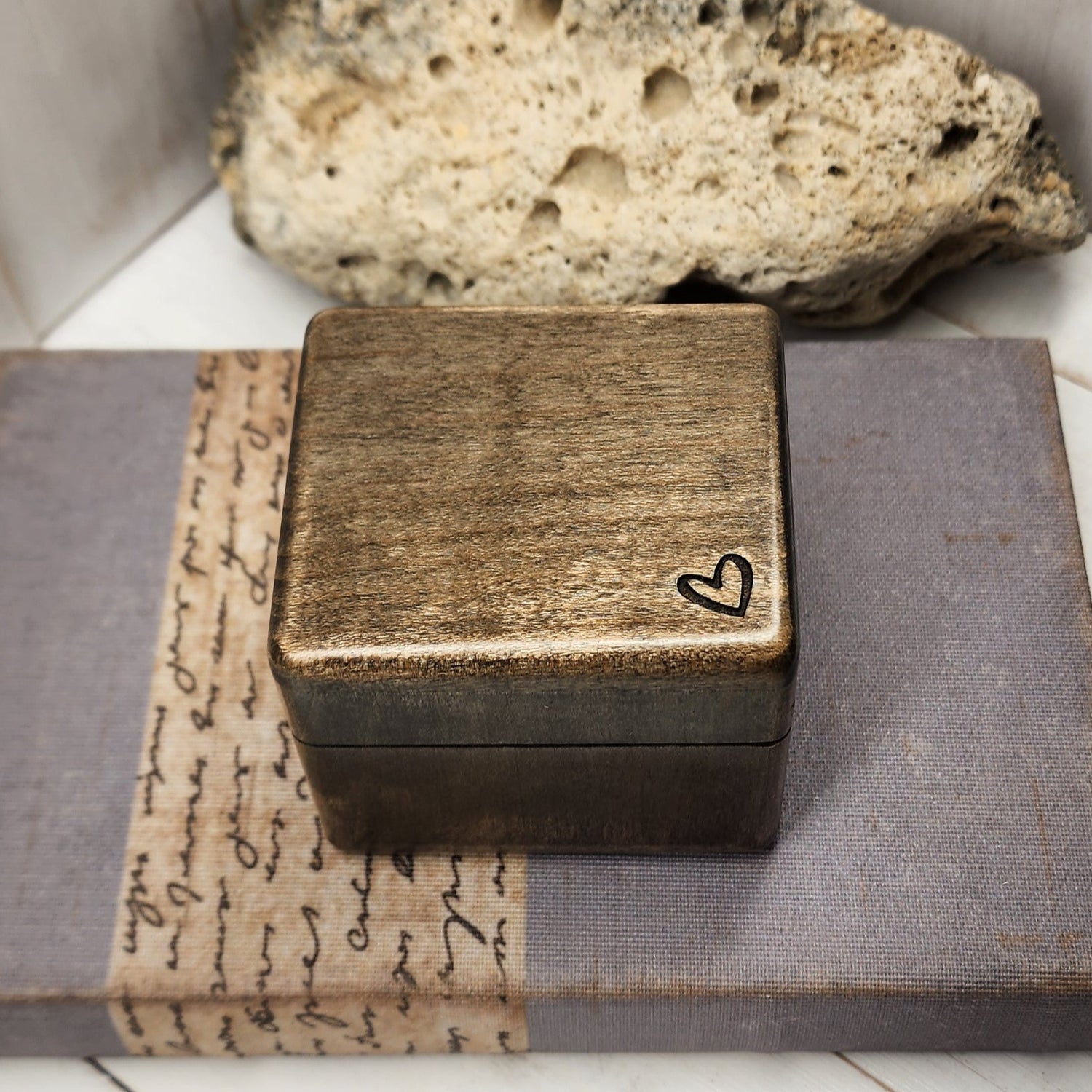 wooden ring box with a tiny heart engraved in the corner, plays your song