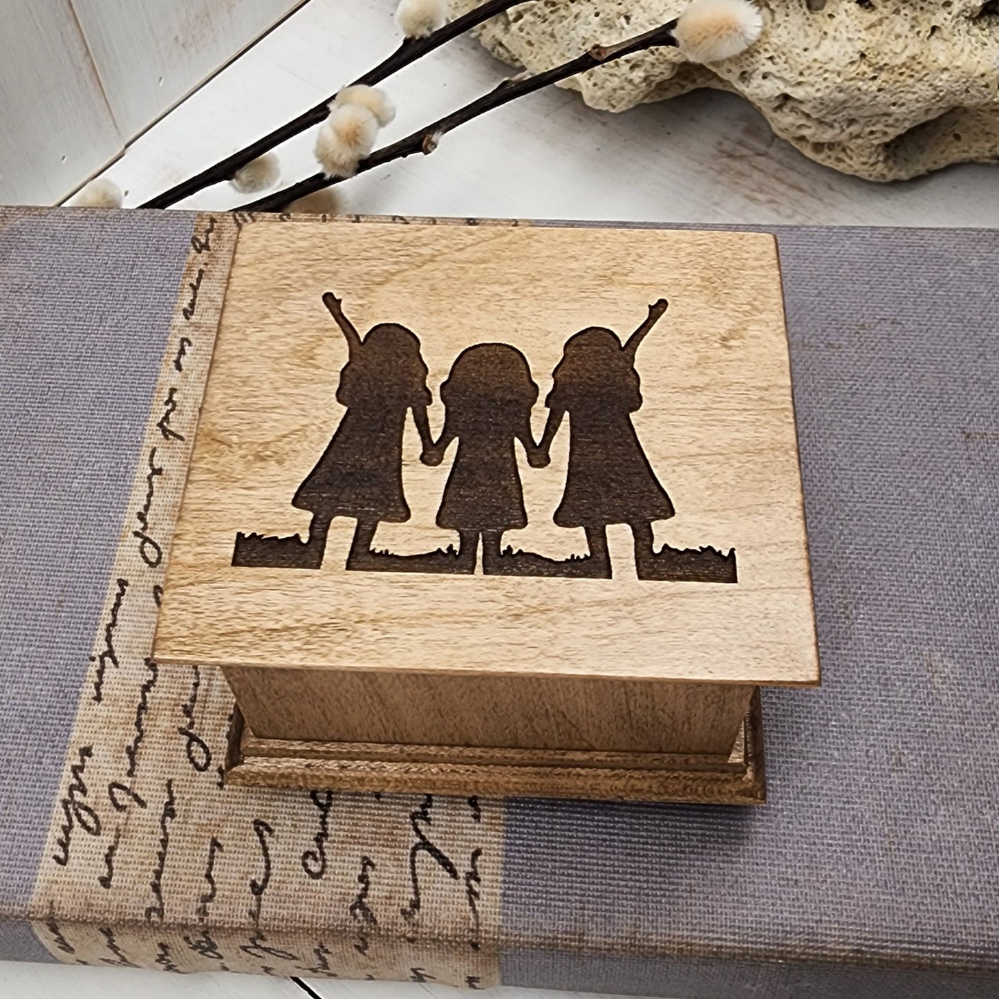 music box with 3 girls holding hands engraved on top, choose color and song, add a personalized message to the bottom side