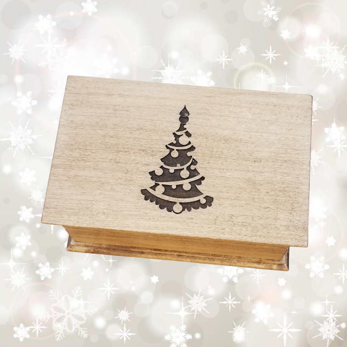 Wooden box with a Christmas tree design on a sparkling background
