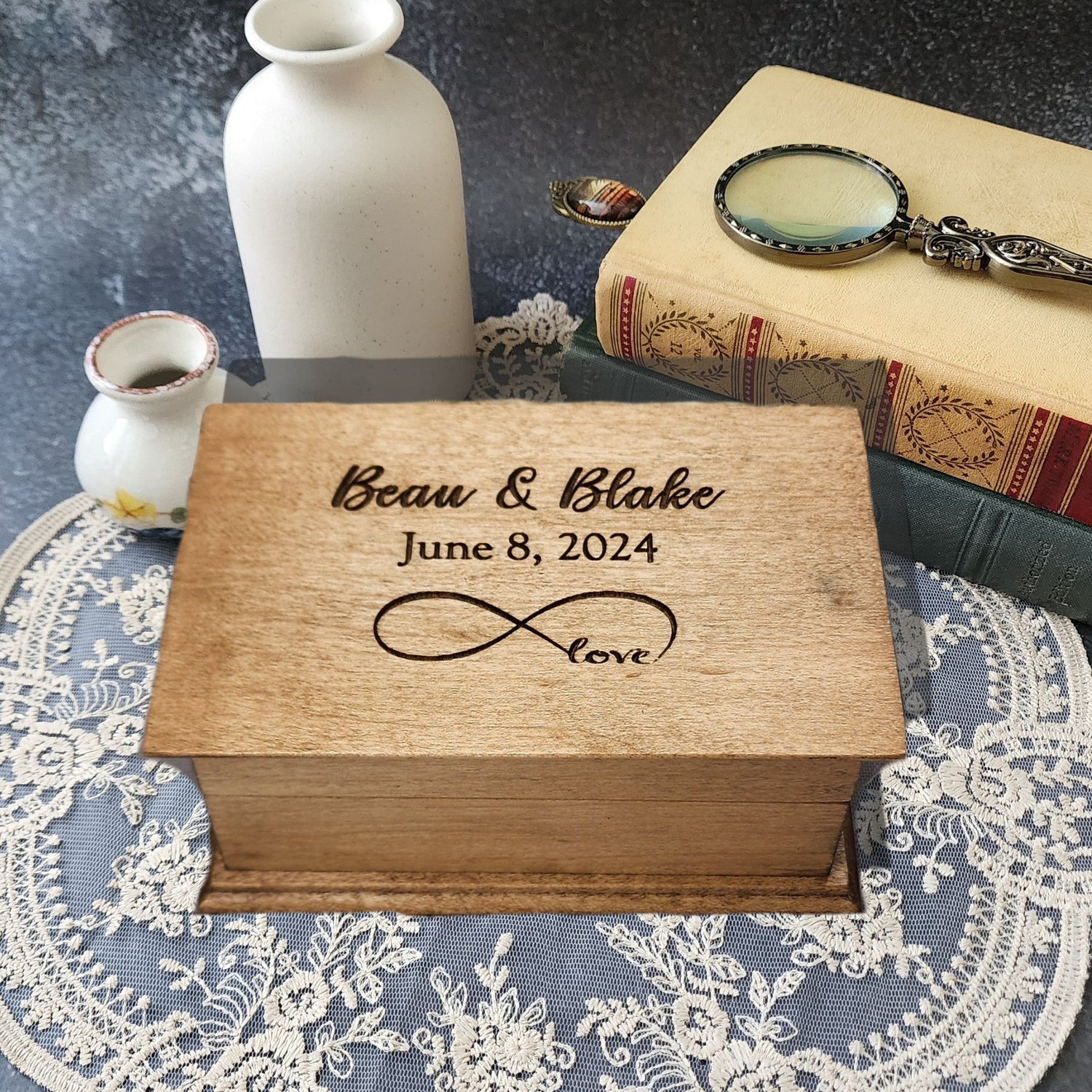 Personalized infinity love music box engraved with names “Beau & Blake,” date “June 8, 2024,” and infinity symbol with word “love.”