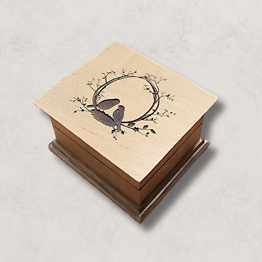 Custom wooden wind-up music box with love birds engraving, available in 16 colors and personalized with a song choice and bottom engraving.