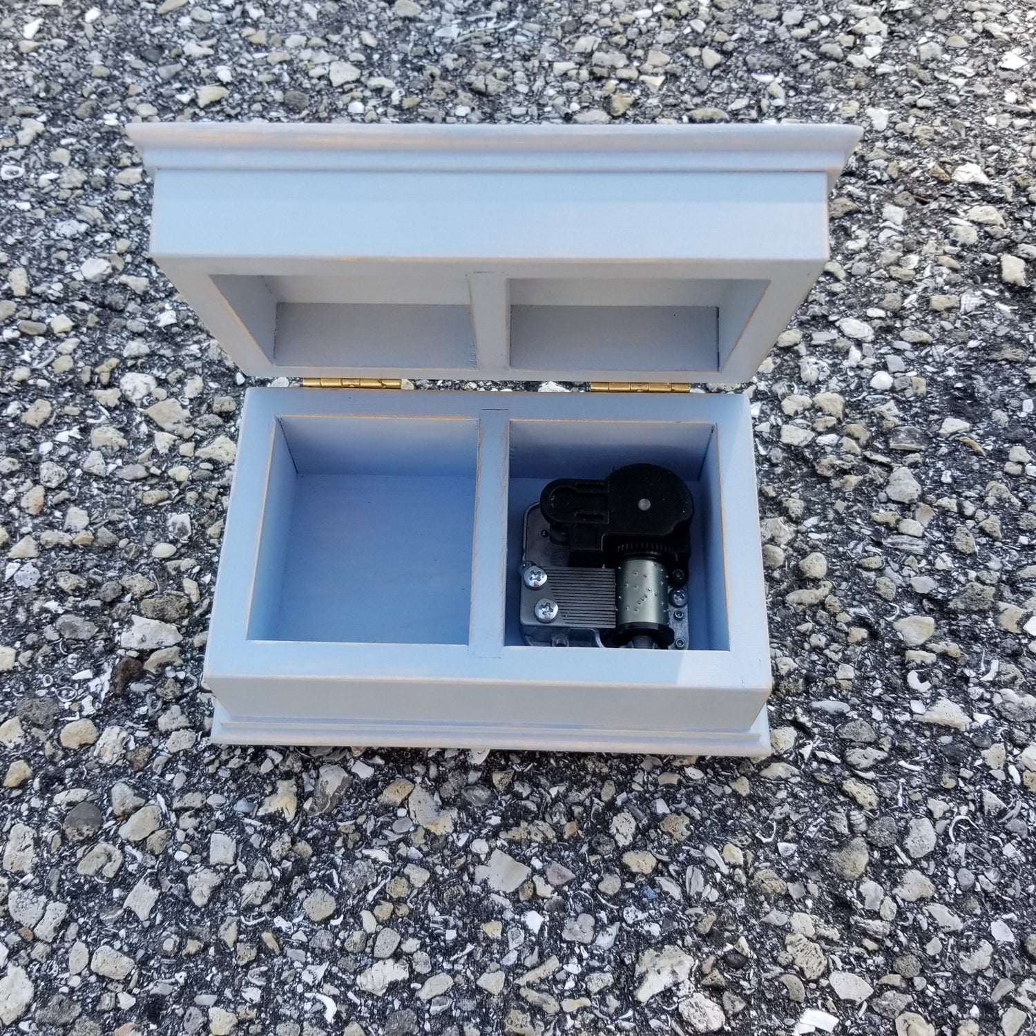 wooden jewelry box with an open lid in light blue