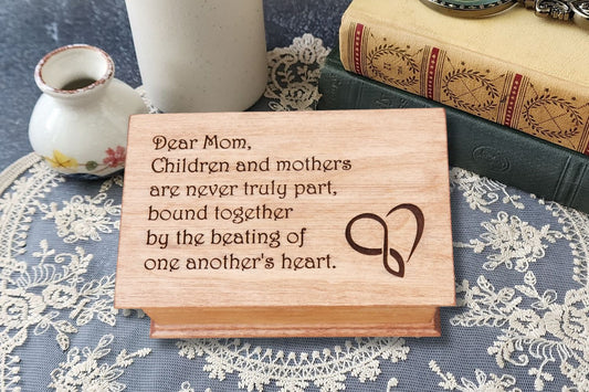 Personalized wooden music box engraved with heartfelt message for Mom, unique handmade Mother’s Day gift for music lovers.