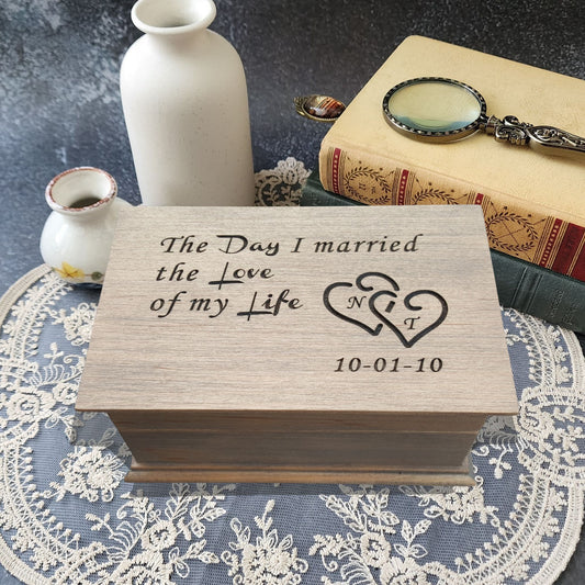 Personalized wooden anniversary music box engraved with “The Day I married the Love of my Life,” intertwined hearts with initials, and wedding date.