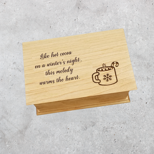 Handmade Christmas music box engraved with hot cocoa mug and holiday quote: " Like hot cocoa on a winter's night, this melody warms the heart. "