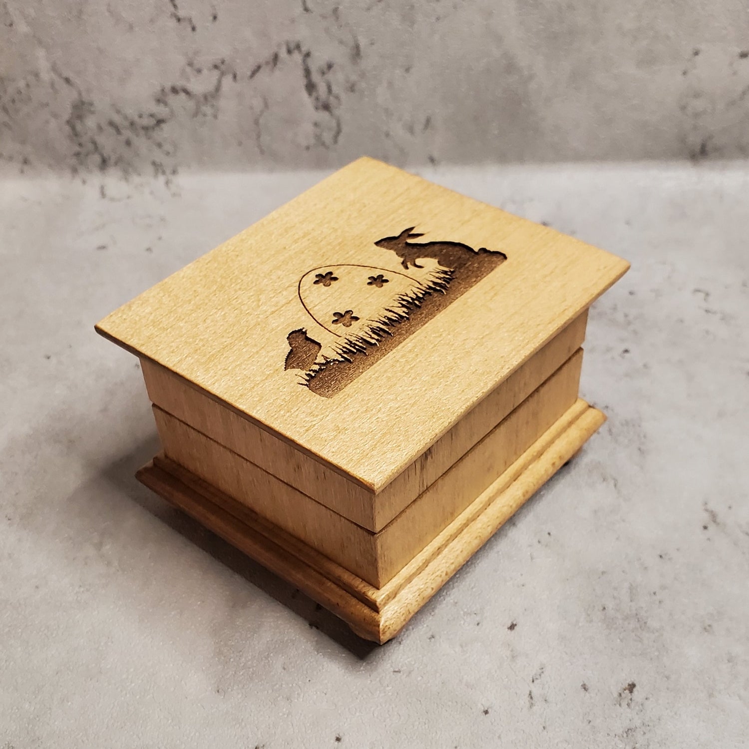 Easter music box with Easter egg, Easter bunny and baby chick engraved on top of the music box with a name under the image, choose color and song
