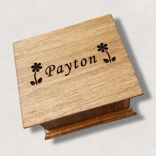 Wooden music box with 2 daisies and the name 'Payton' engraved on a light natural background