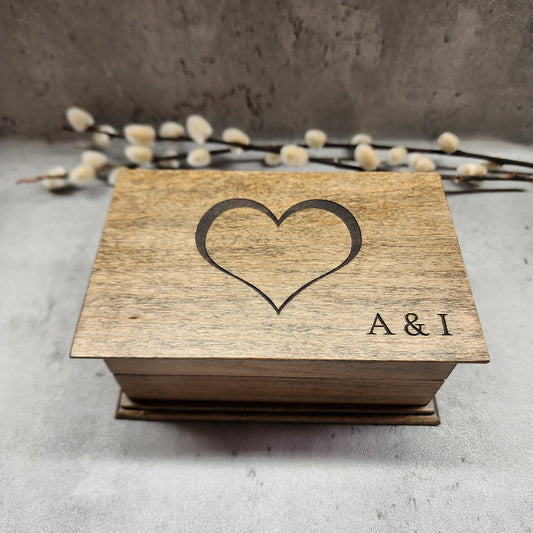 Heart with initials engraved on top on wooden jewelry box, plays your song and color