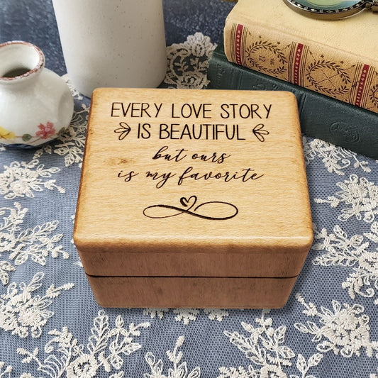 Wooden music ring box engraved with the quote “Every love story is beautiful but ours is my favorite,” perfect handmade romantic gift for weddings, anniversaries, or Valentine’s Day.