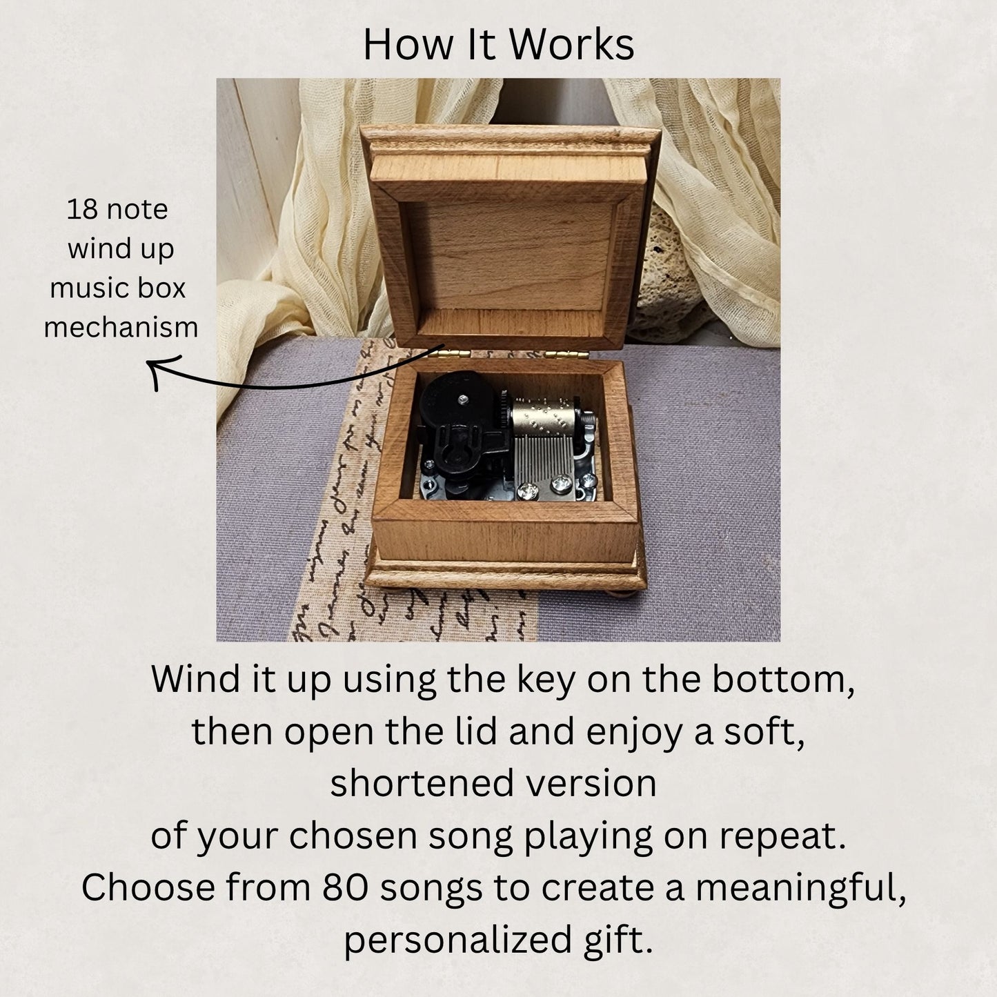 Wooden music box with the lid opened showing the 18 note wind up music box mechanism inside with a text explaining its mechanism and song selection.