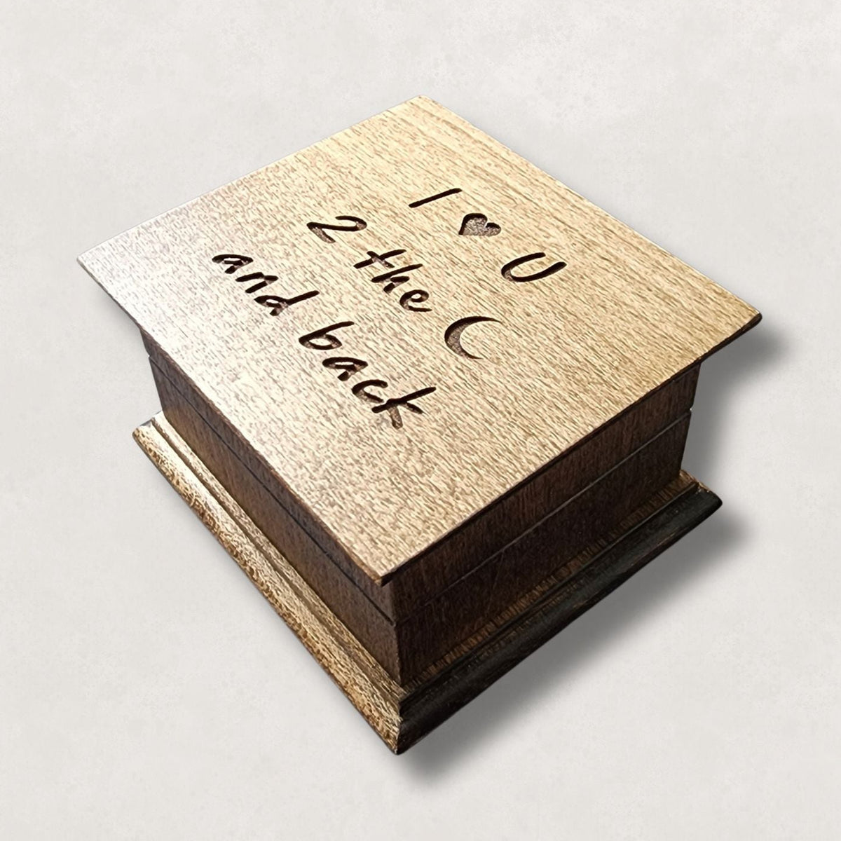 wooden music box with I ♥ U to the moon and back engraved on the top, choice of 80 songs, 16 colors and option  to add personalized engraving to the bottom. Music box by Simplycoolgifts