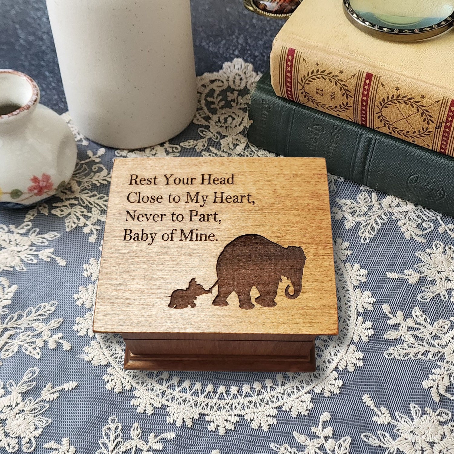 small wooden music box in chestnut with a momma and baby elephant silhouette engraved on the top along with the quote Rest Your Head Close to My Heart.... , choose the song Baby Mine and create a one-of-a-kind keepsake