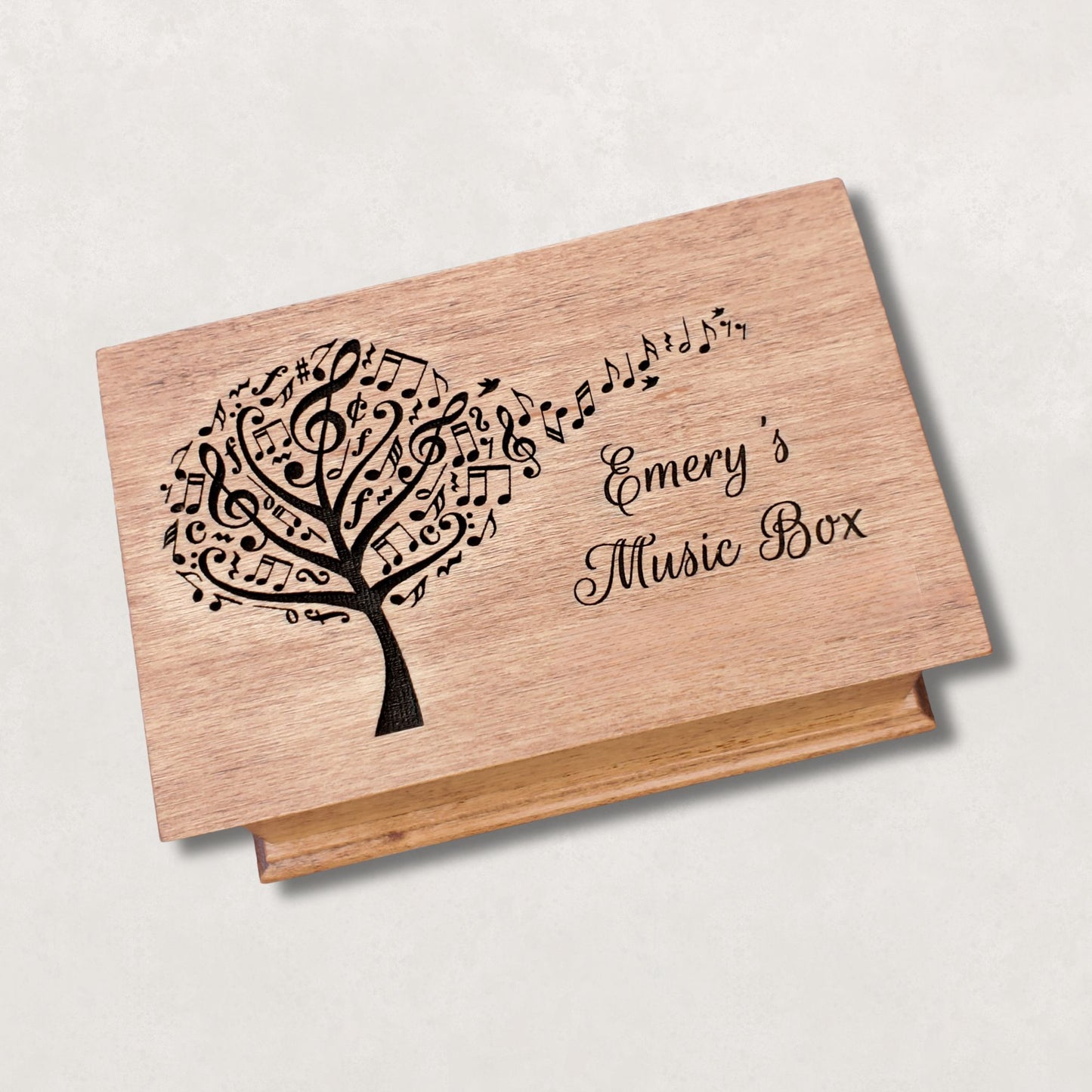 Personalized wooden jewelry box with engraved music tree design and name ‘Emery’s Music Box,’ handcrafted custom song box in natural wood color
