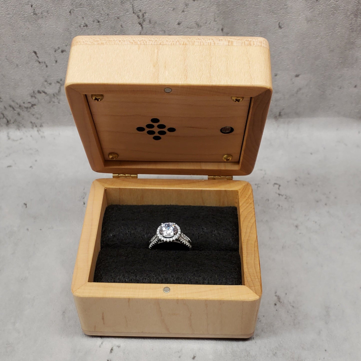 custom-made wooden ring box with a built-in music player under the lid, there is a black felt ring insert inside to hold the ring safely