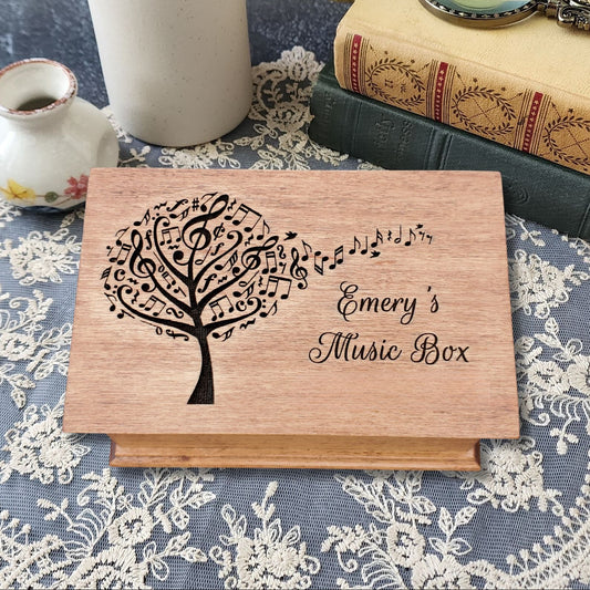 Personalized wooden jewelry box with engraved music tree design and name ‘Emery’s Music Box,’ handcrafted custom song box in natural wood color