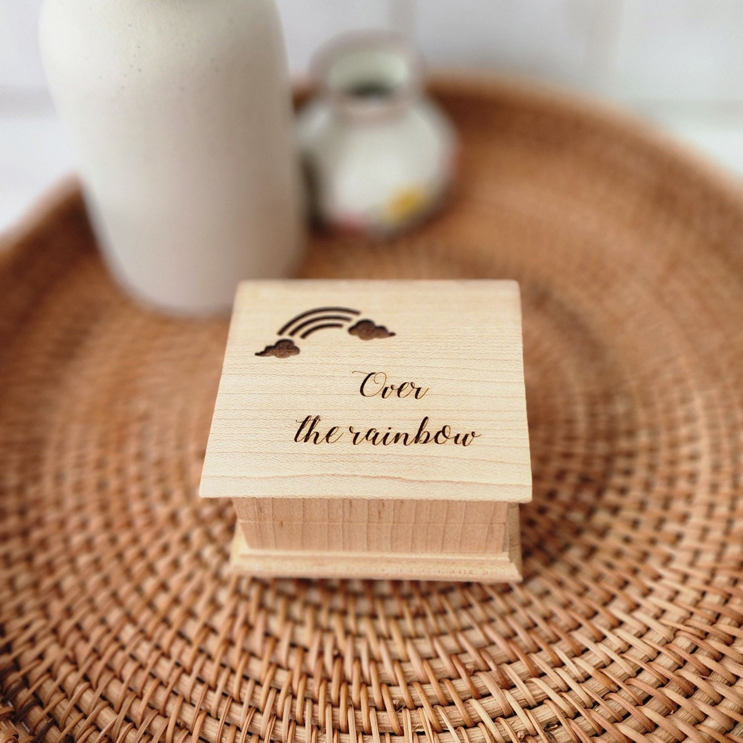 Small handcrafted wooden music box engraved with a rainbow and the words “Over the Rainbow"
