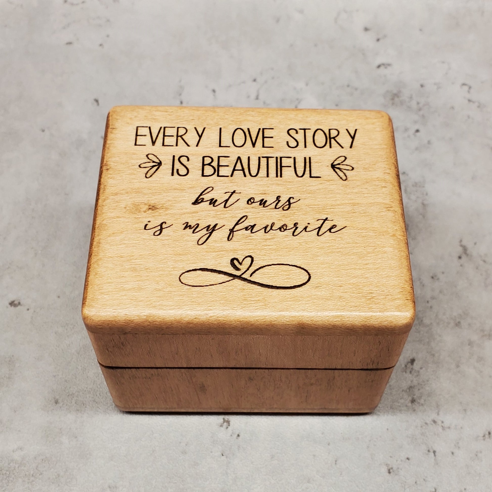Wooden ring box with engraved text "Every Love Story is beautiful but ours is my favorite with infinity love symbol. Choose from 9 colors and add your song