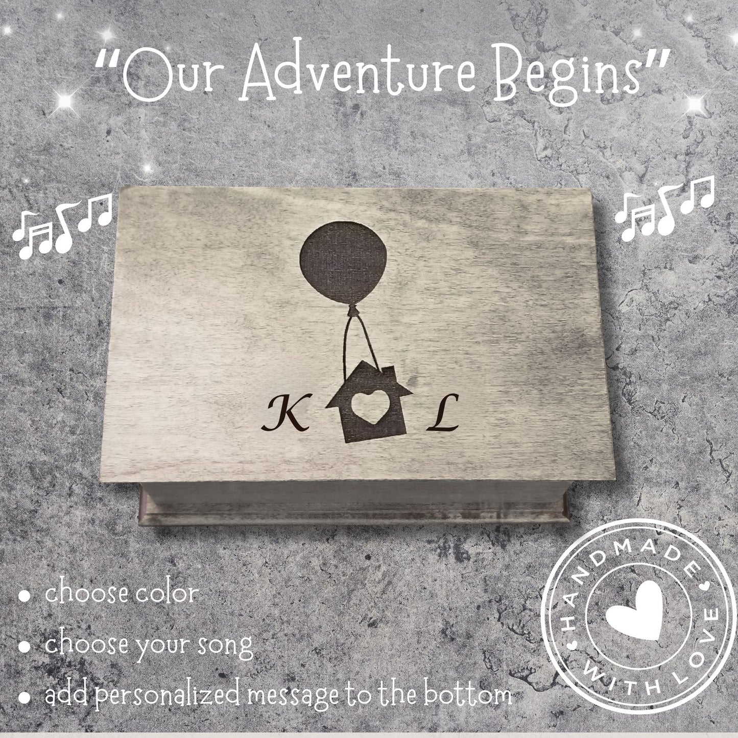 Wooden music box with 'Our Adventure Begins' text and a balloon house with initials on a gray background