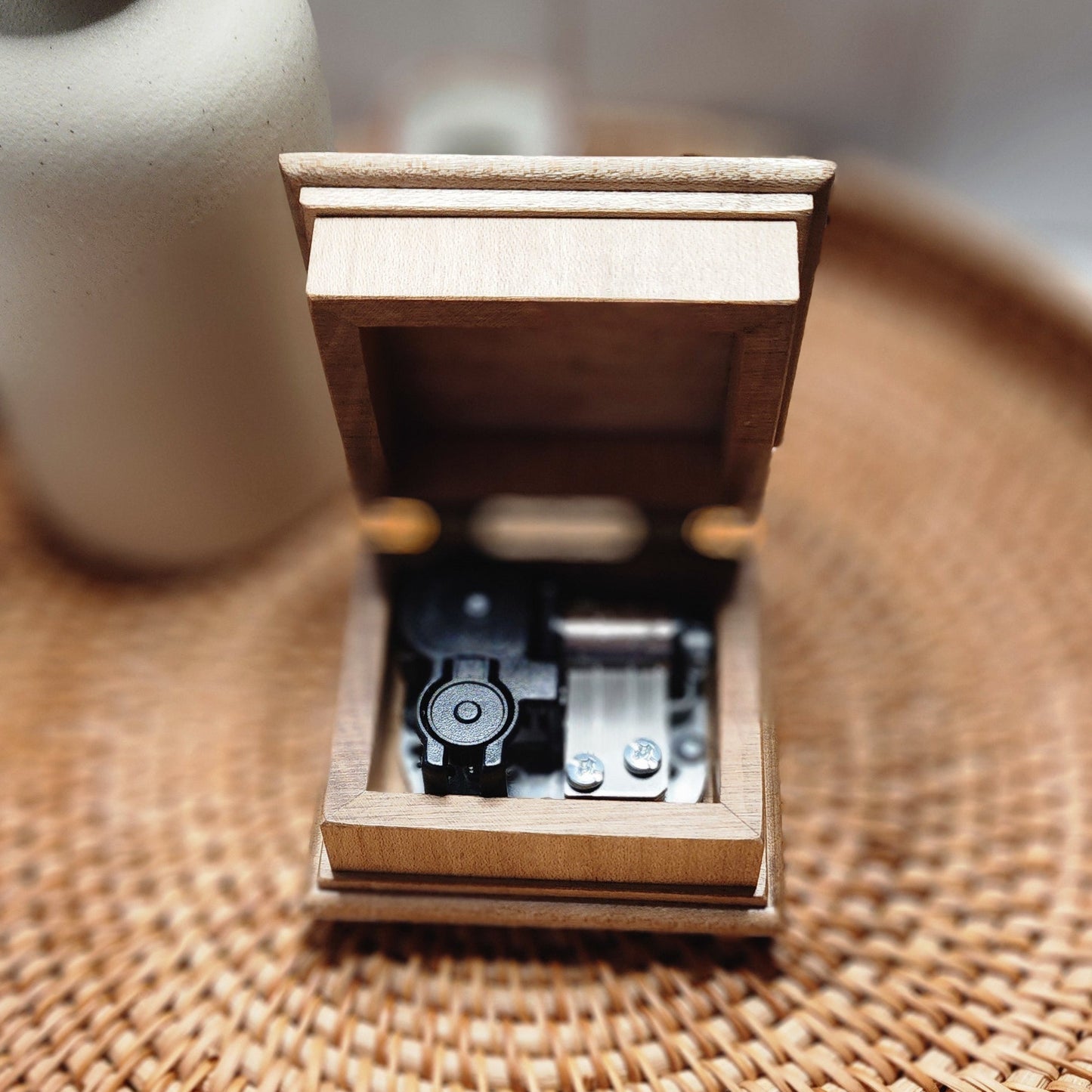 music box with the lid open showing the 18 note wind up music box mechanism on the inside