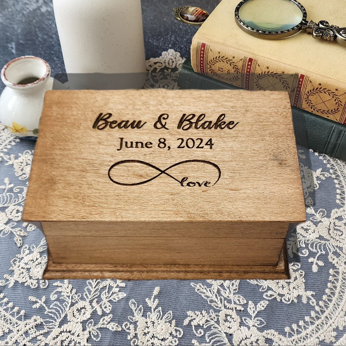 Personalized infinity love music box engraved with names “Beau & Blake,” date “June 8, 2024,” and infinity symbol with word “love.”