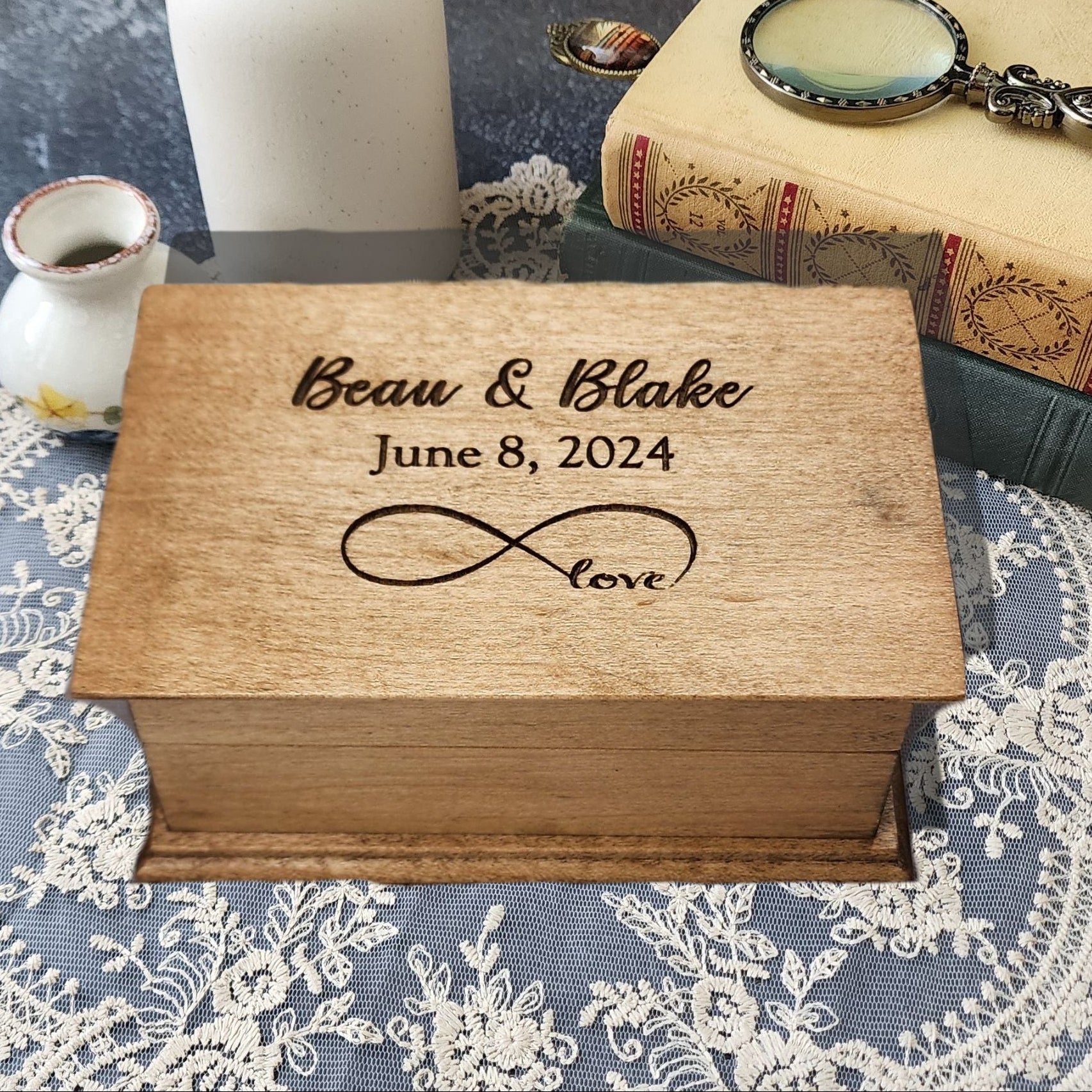 Personalized infinity love music box engraved with names “Beau & Blake,” date “June 8, 2024,” and infinity symbol with word “love.”