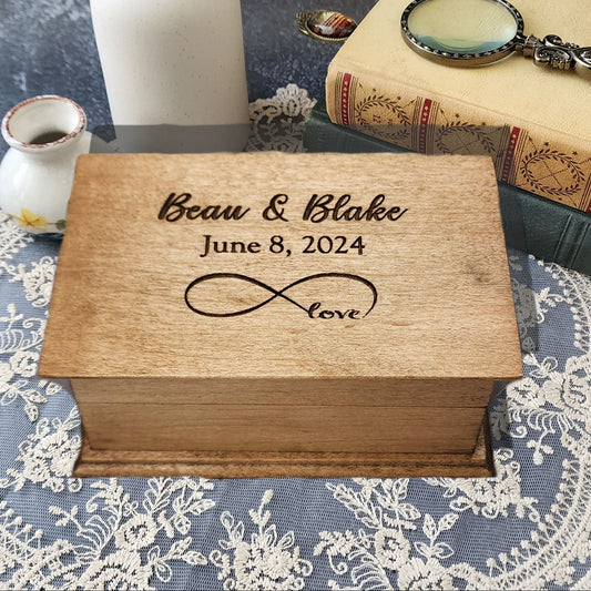 Personalized infinity love music box engraved with names “Beau & Blake,” date “June 8, 2024,” and infinity symbol with word “love.”