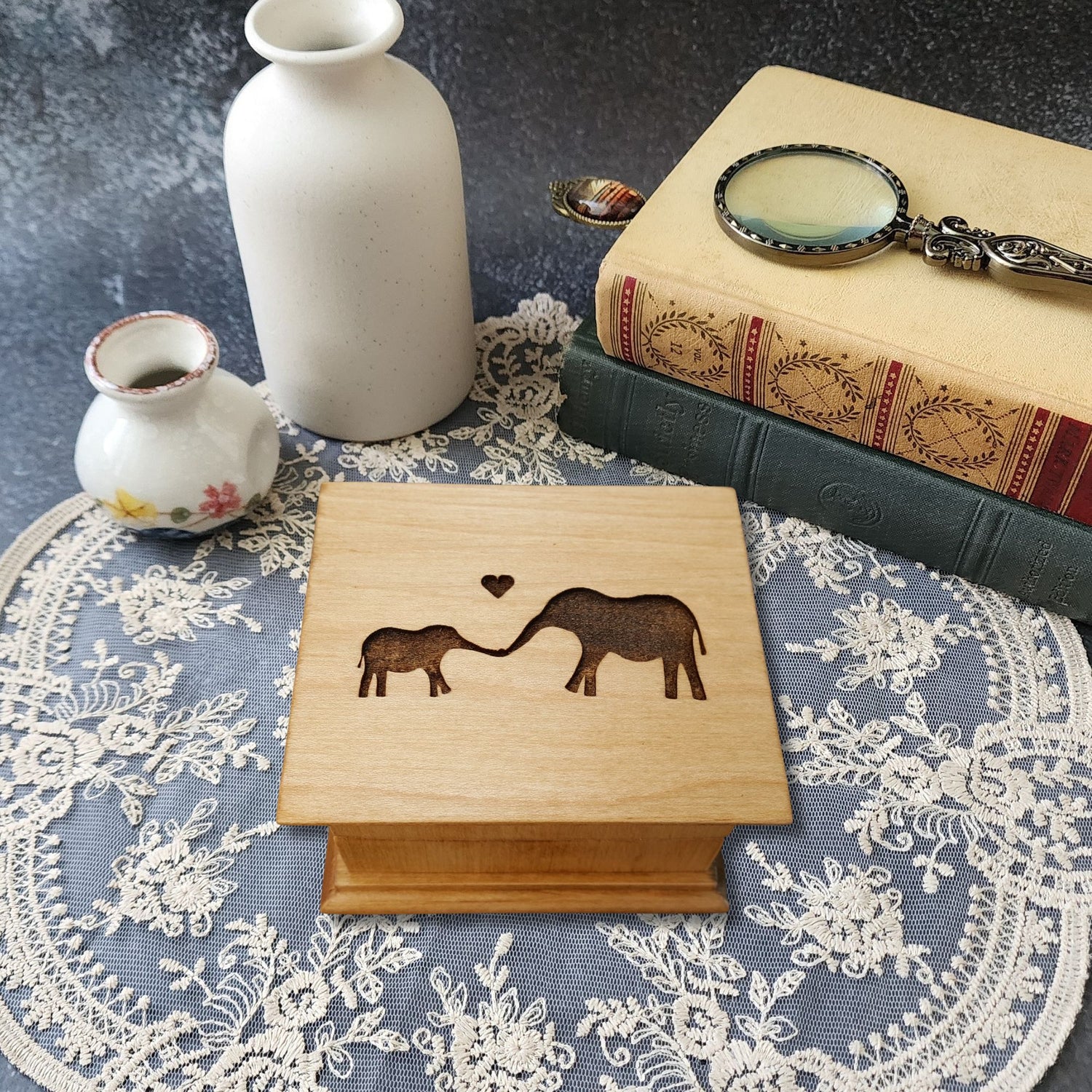 Personalized baby elephant music box handmade in Florida, engraved mom and baby elephant design, maple wood keepsake gift box on lace table setting