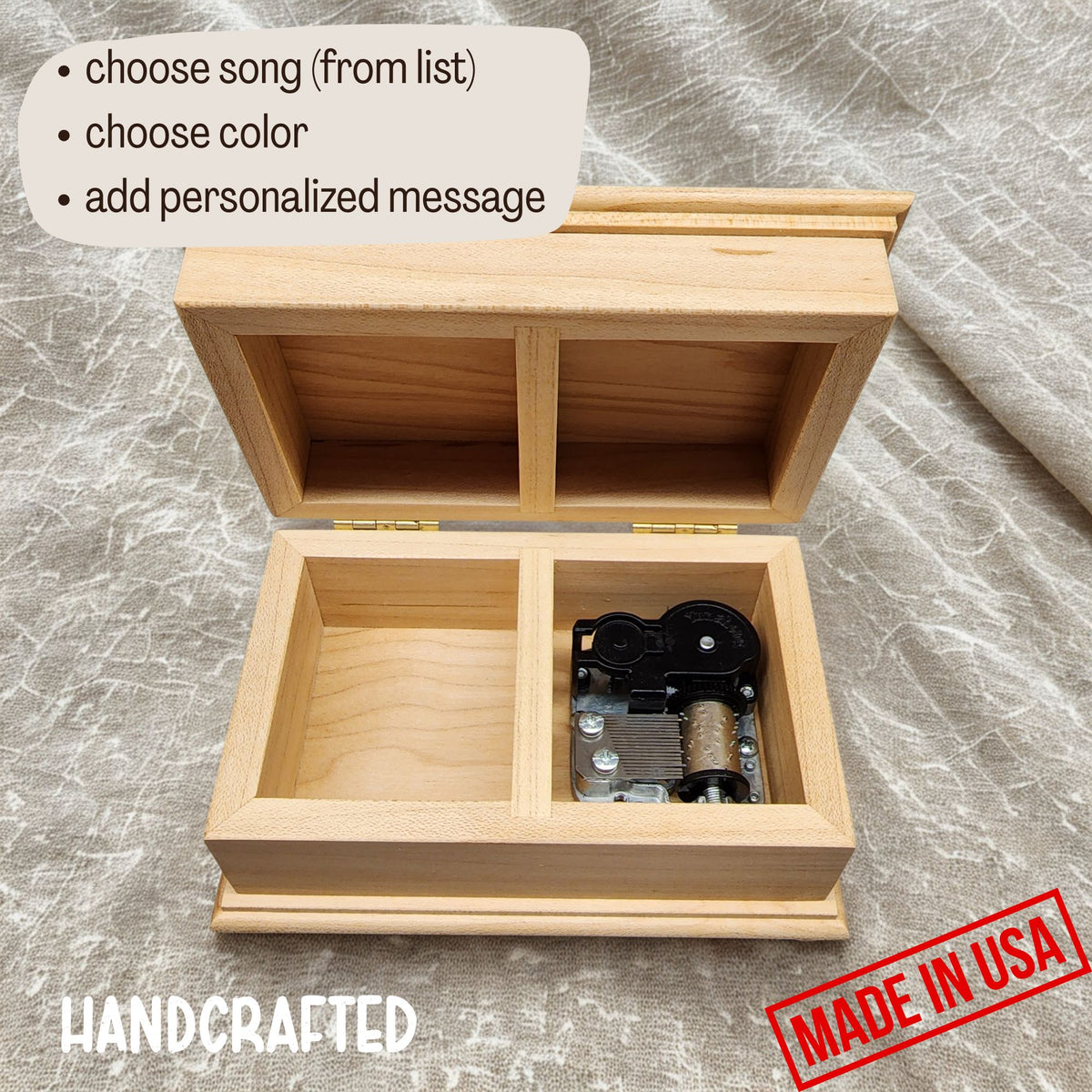 wooden music box with the lid open showing the wind up music box mechanism and an additional compartment for some small jewelry 