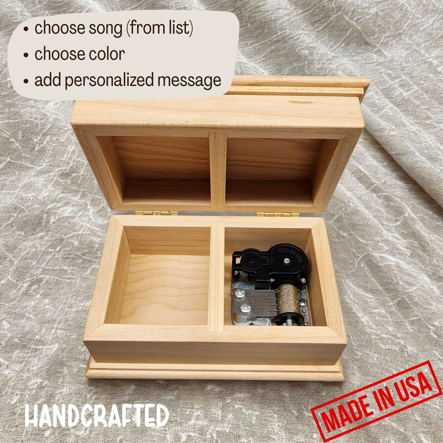 wooden music box with the lid open showing the wind up music box mechanism and an additional compartment for some small jewelry 