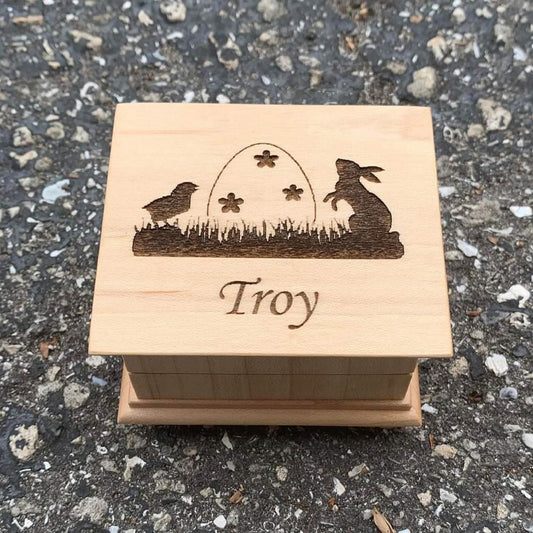Easter music box with Easter egg, Easter bunny and baby chick engraved on top of the music box with a name under the image, choose color and song