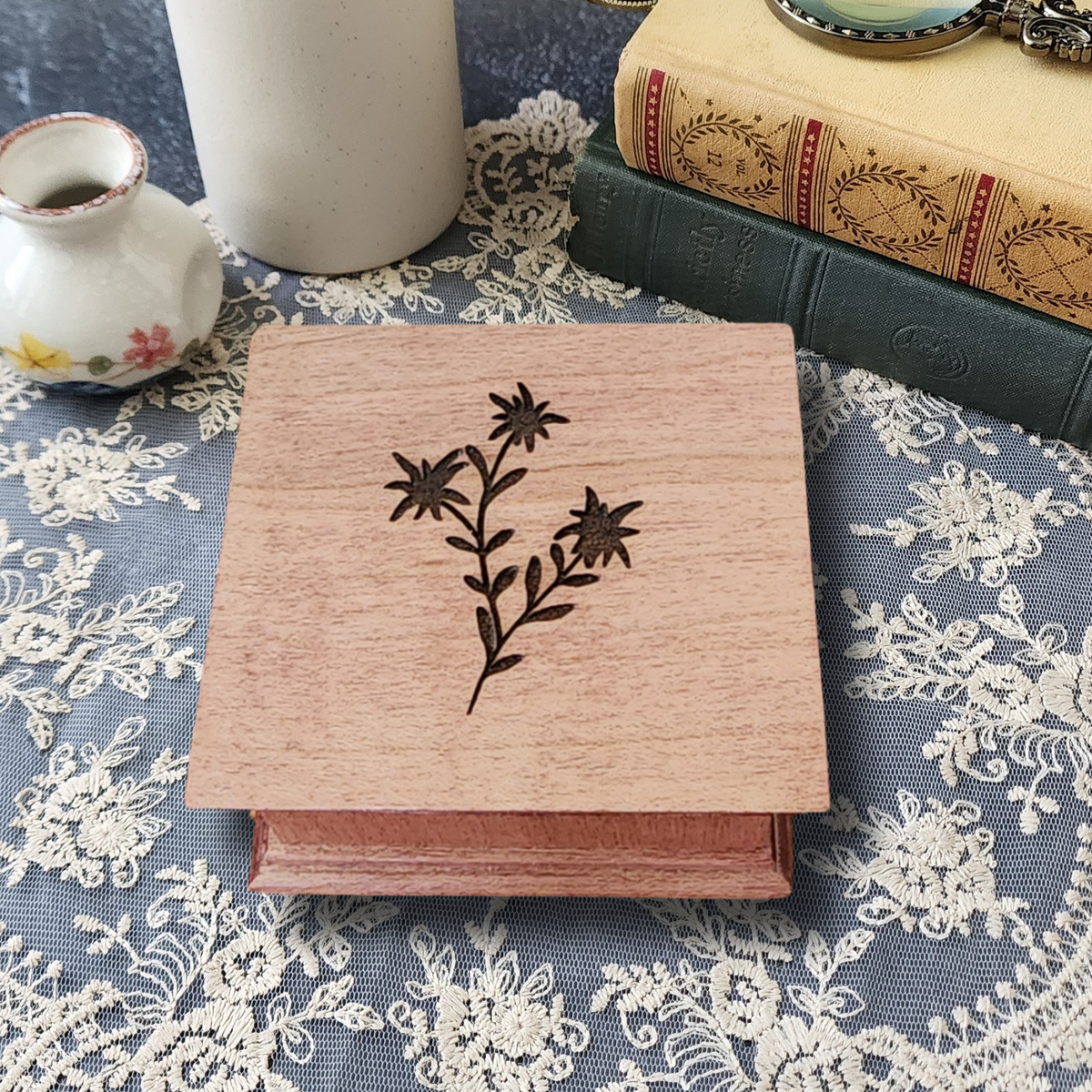 flower engraved music box on a lace tablecloth