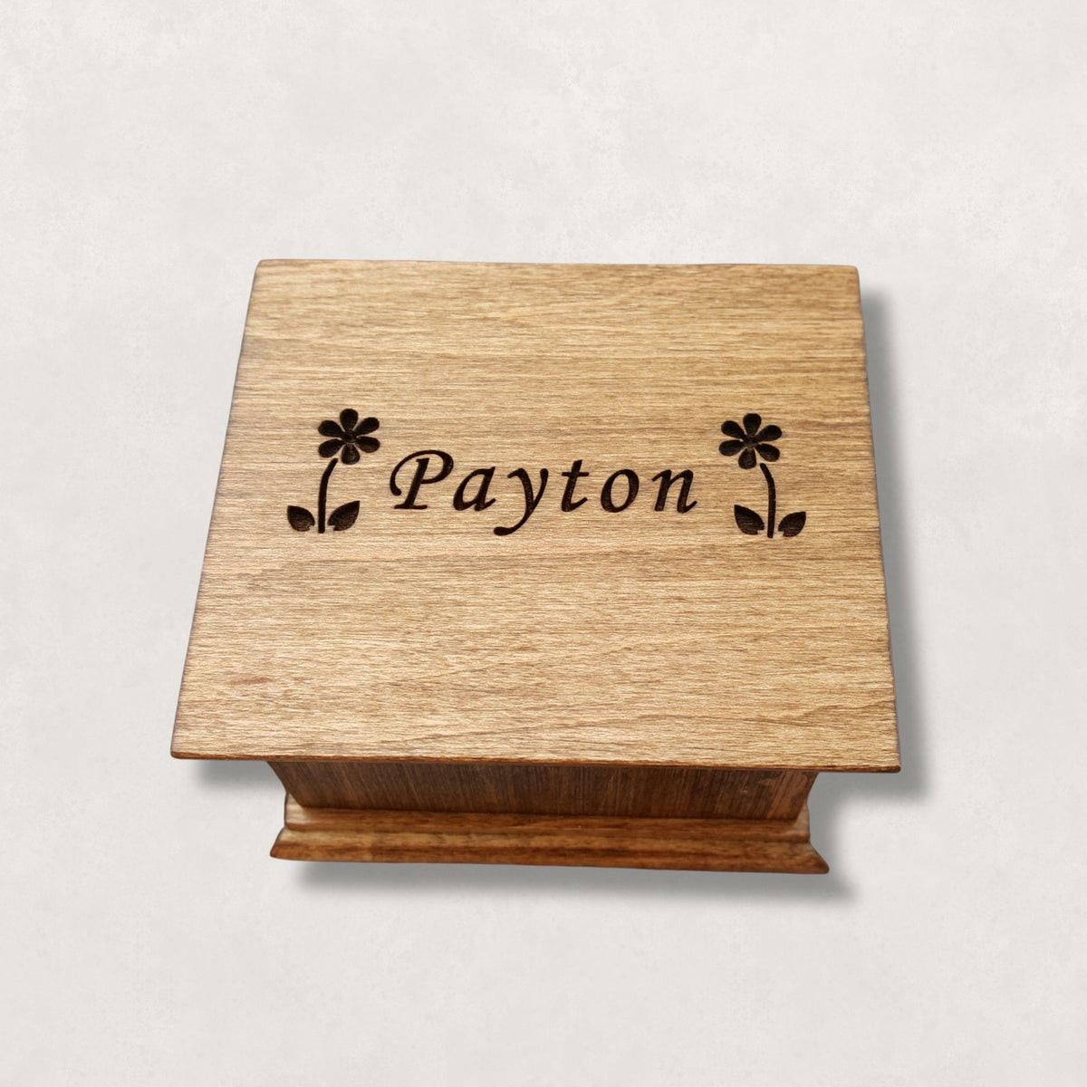 Music box with 'Payton' engraved on a light gray background made with maple wood