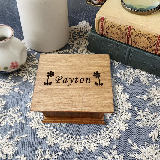 Small wooden wind-up music box with flower and name engraving – personalized handmade keepsake gift.