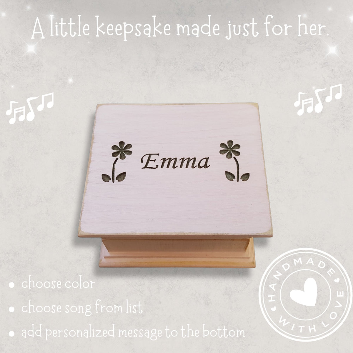 Personalized wooden music box with 'Emma' between 2 daisies engraved on a light gray background