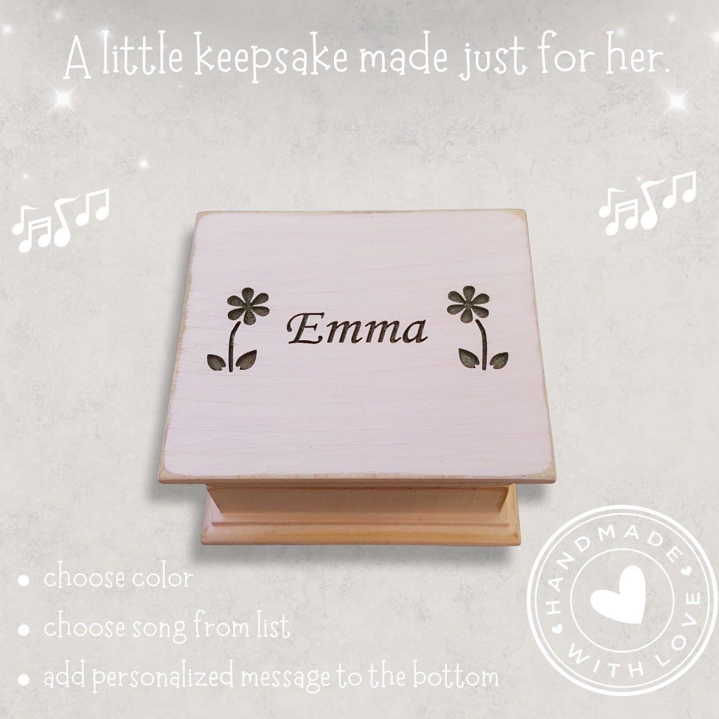 Personalized wooden music box with 'Emma' between 2 daisies engraved on a light gray background