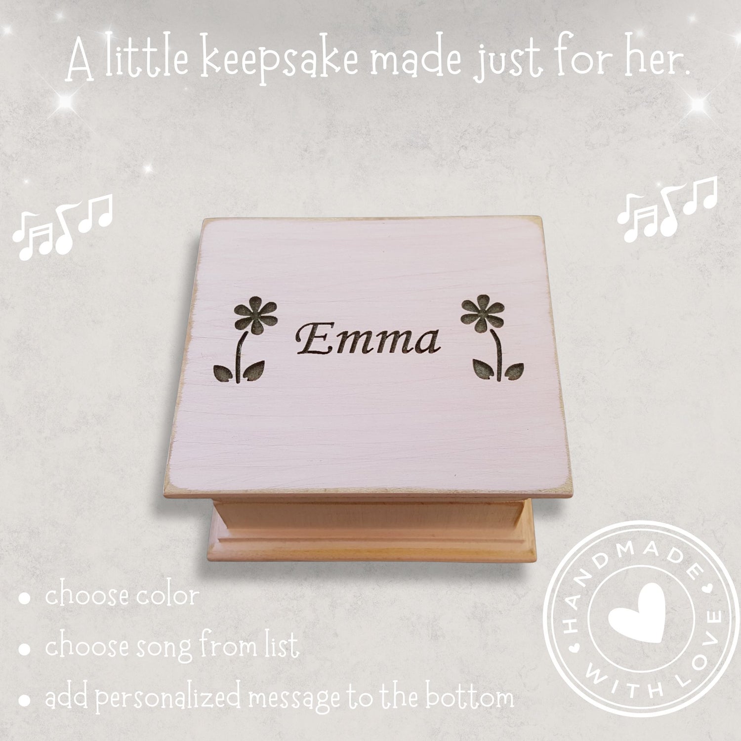 Personalized wooden music box with 'Emma' between 2 daisies engraved on a light gray background