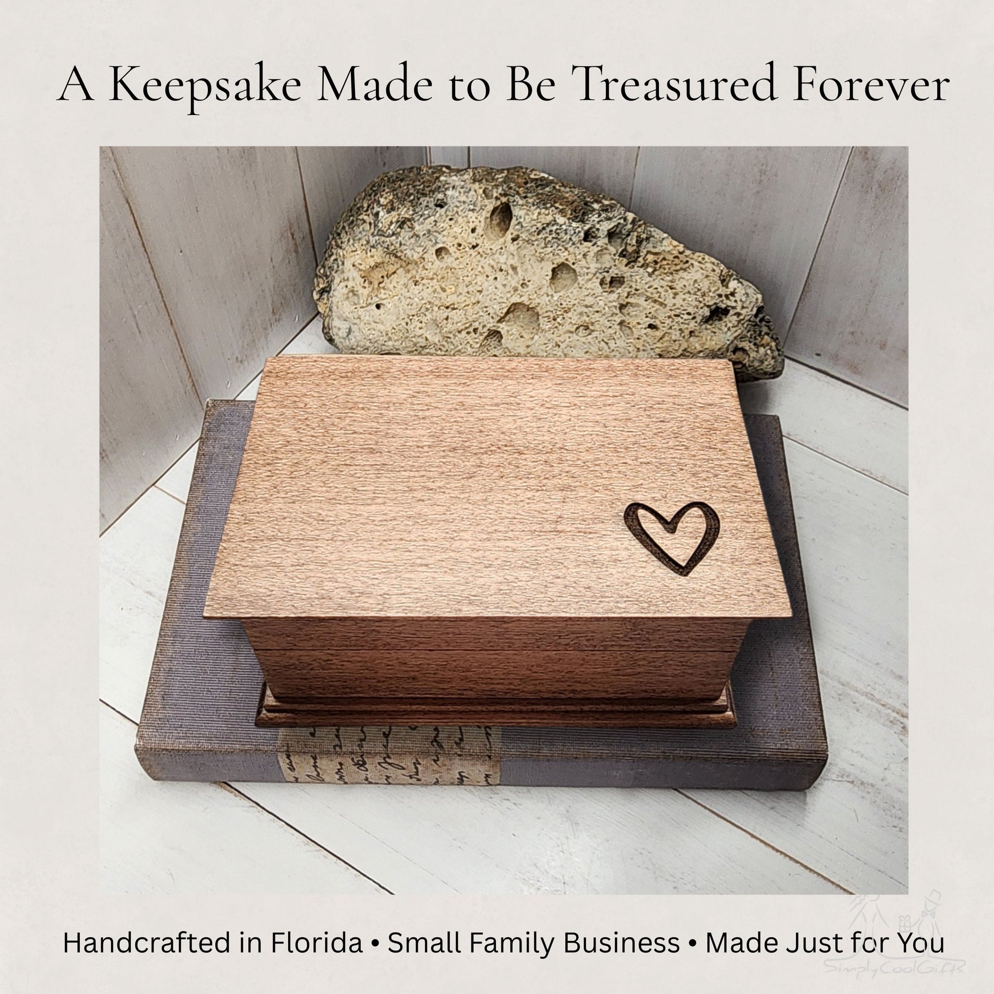 Wooden jewelry box with a heart engraving on a stone surface, with text about a keepsake being treasured forever.