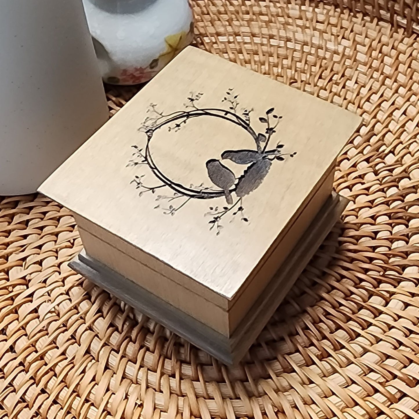 Custom wooden wind-up music box with love birds engraving, available in 16 colors and personalized with a song choice and bottom engraving.