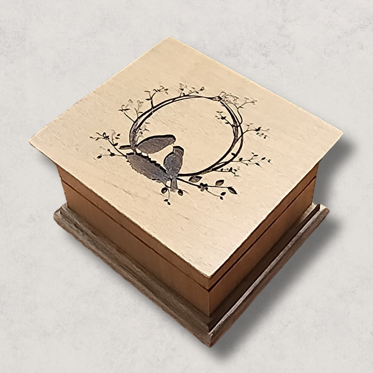 Custom wooden wind-up music box with love birds engraving, available in 16 colors and personalized with a song choice and bottom engraving.