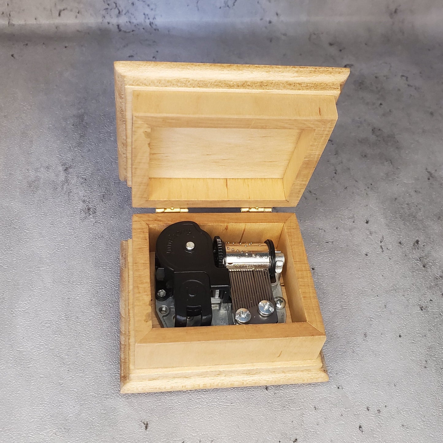 music box with open lid showing 18 note wind up music box movement inside with NO additional space for jewelry, if you'd like a jewelry box, check out the custom song jewelry box section. Handmade in USA, with quality maple wood
