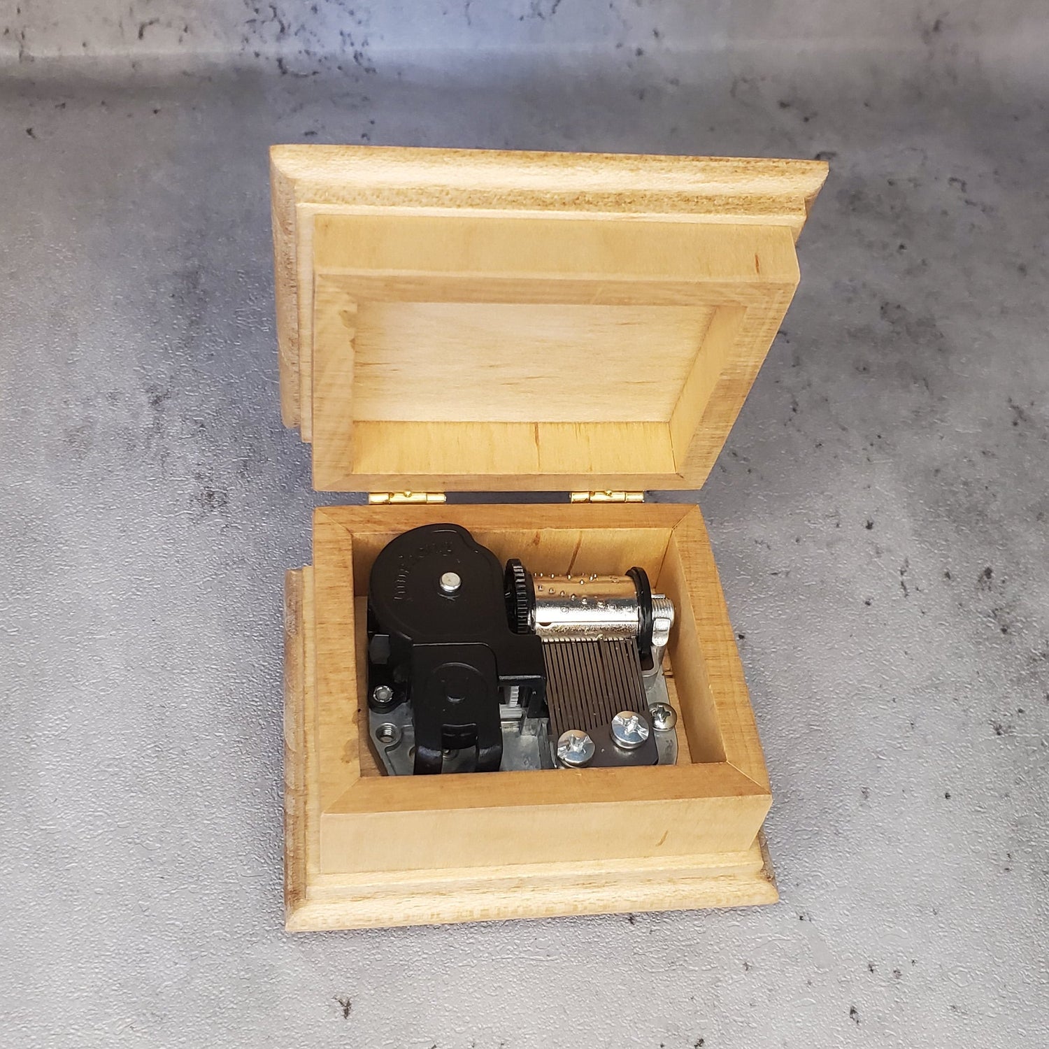 music box with open lid showing 18 note wind up music box movement inside with NO additional space for jewelry, if you'd like a jewelry box, check out the custom song jewelry box section. Handmade in USA, with quality maple wood
