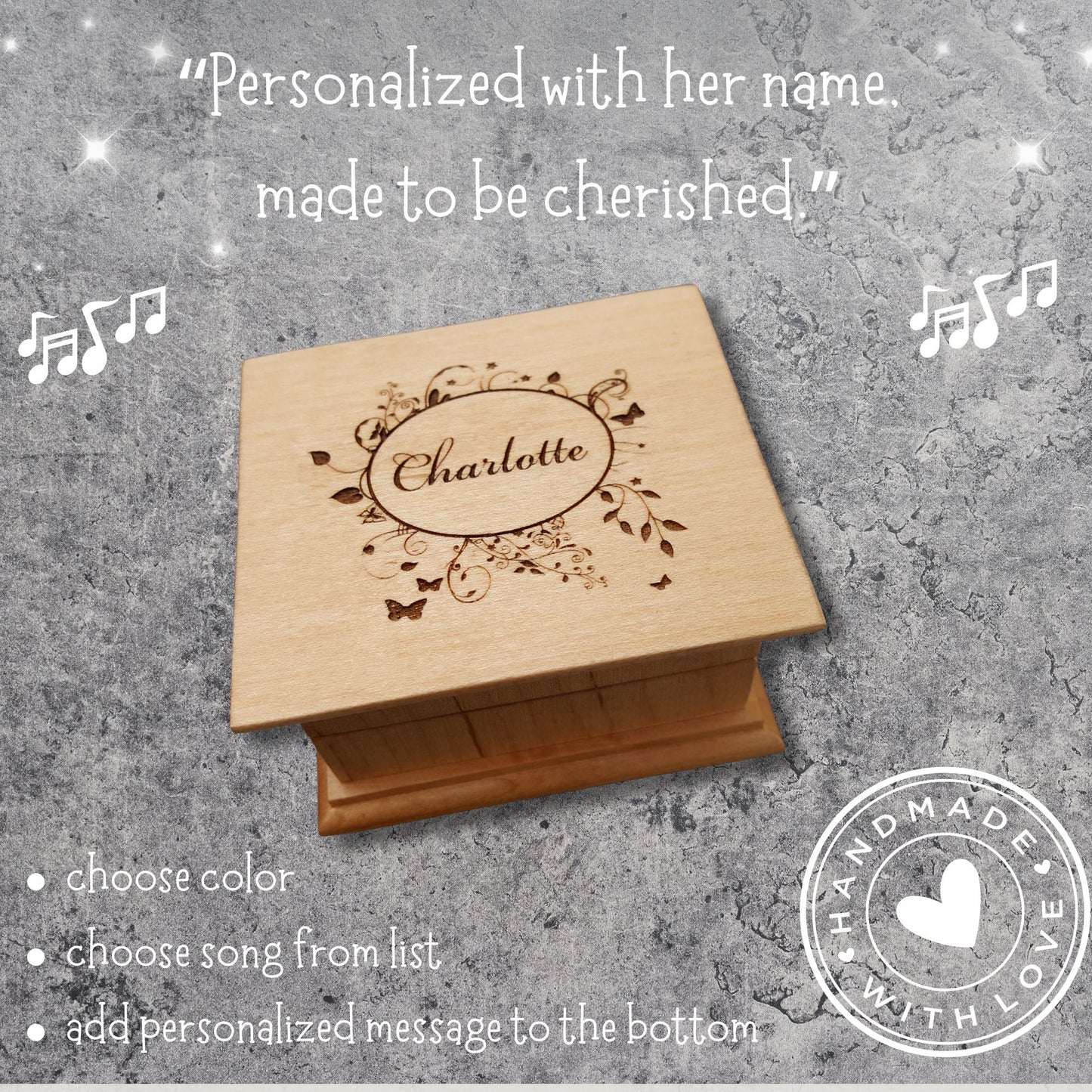 Wooden box with engraved name 'Charlotte' on a textured gray background