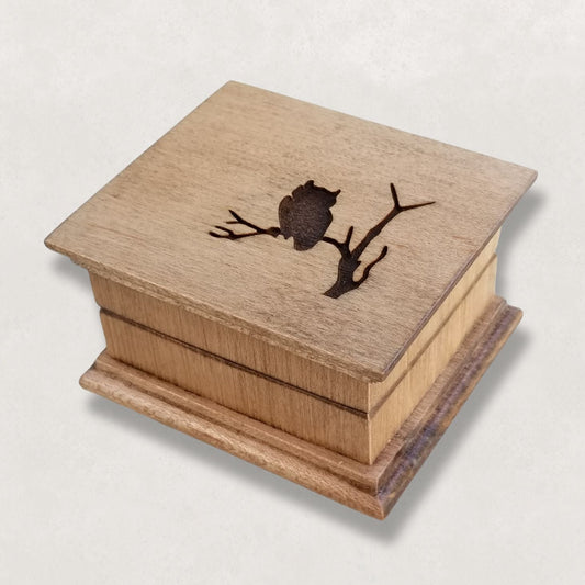Wooden Handcrafted Music box with an owl design on a light gray background