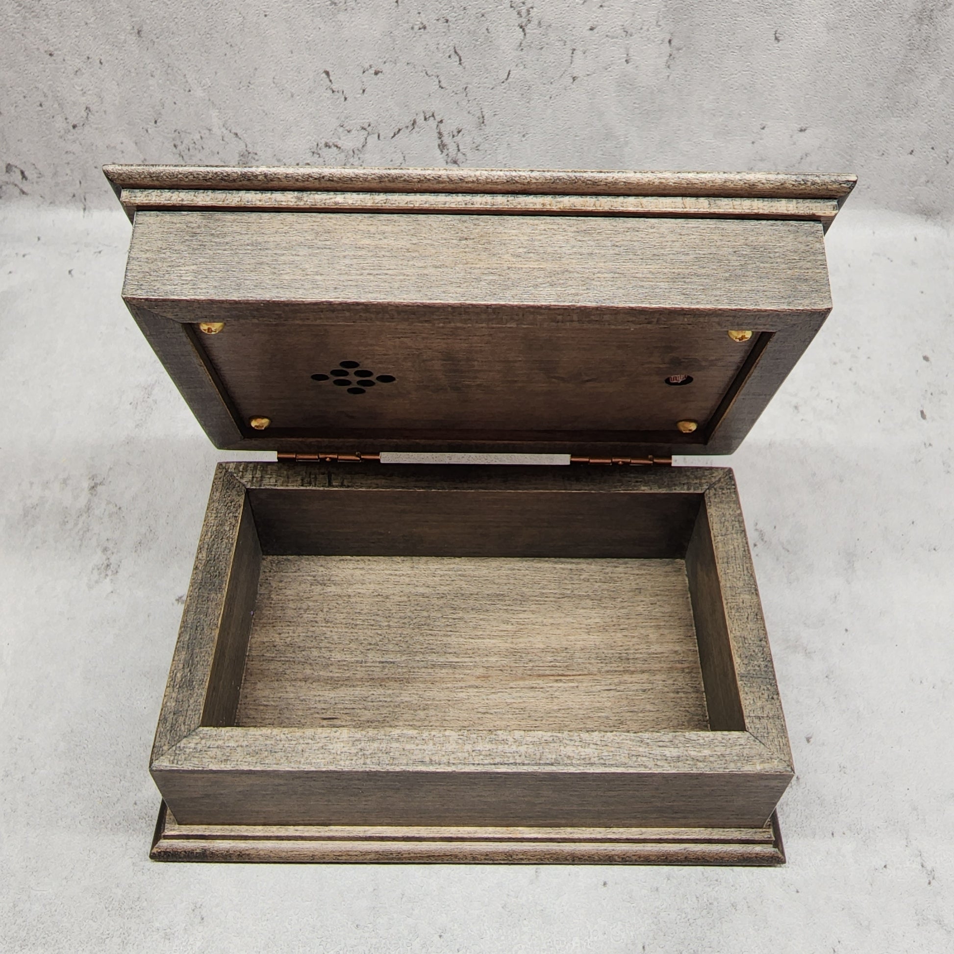 music box made with high quality maple wood and showing the panel under the lid with the holes with the speaker and  the light sensor, choose from 9 different colors, any songs, add personalized engravings to create your unique music box