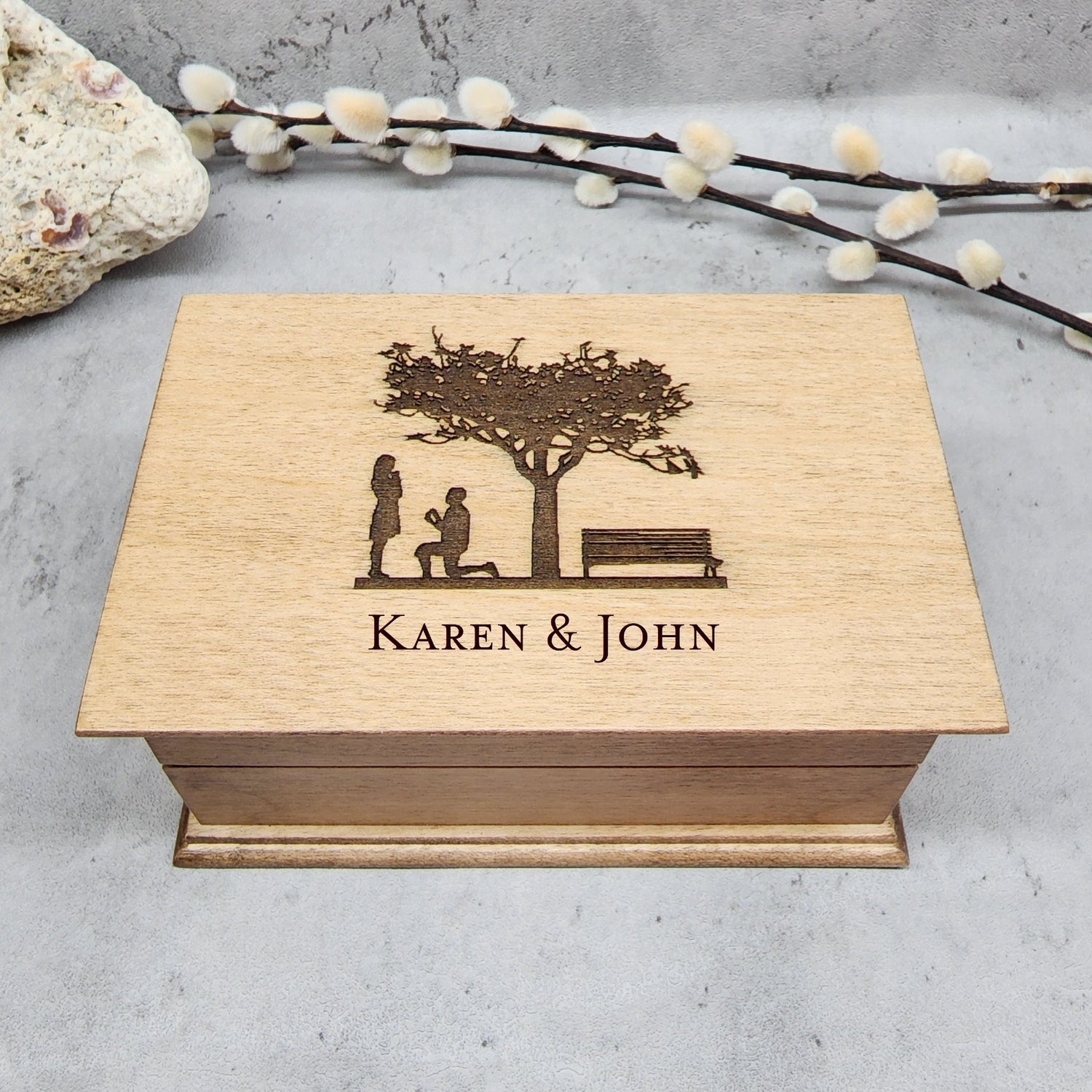 Wooden jewelry box engraved with a tree, a bench and a man on his knees going to propose and a girl, with your names under the image, choose your song and color