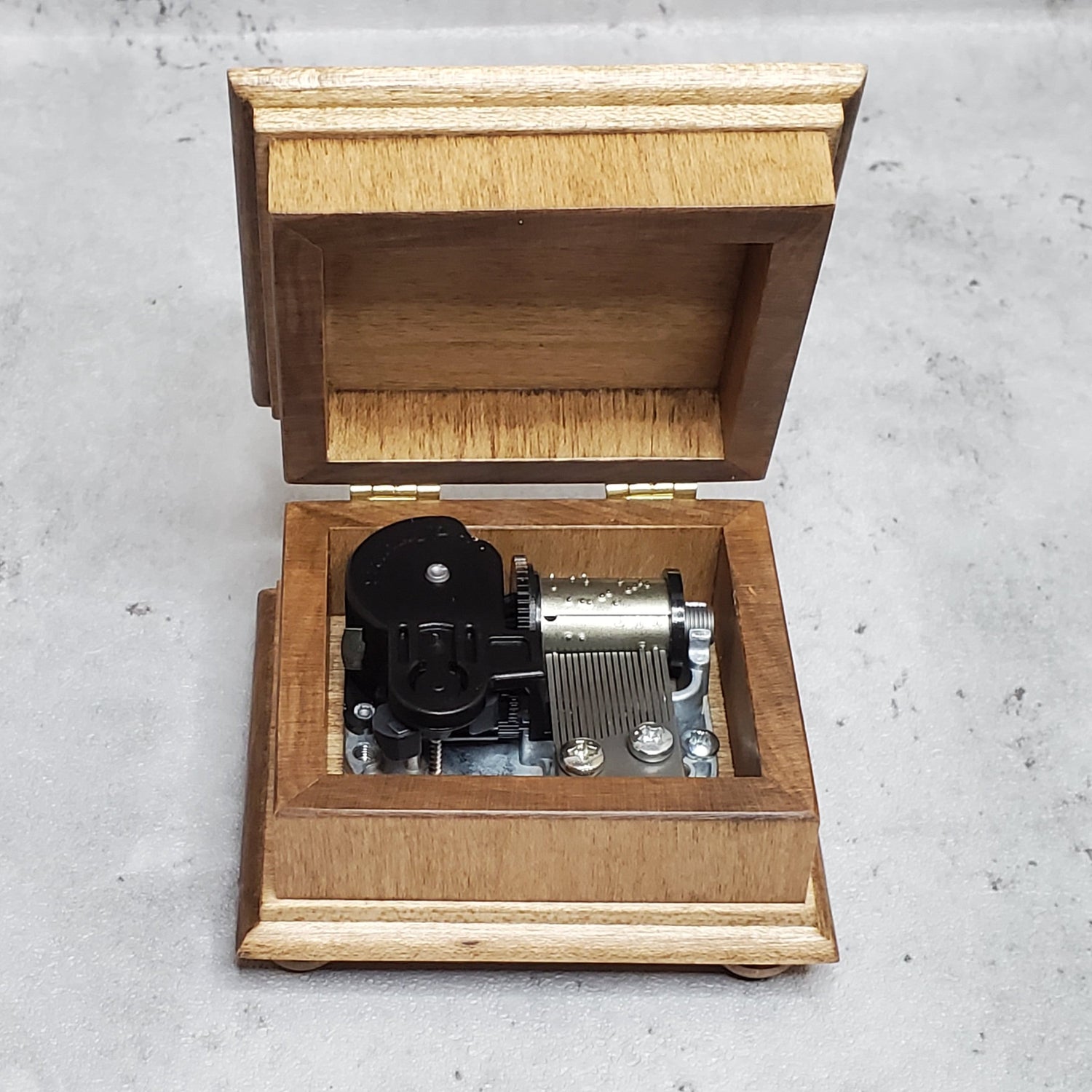 wooden music box with open lid showing music box movement inside, You are my sunshine, I will always love you, Canon in D, Clair de Lune, You light up my life